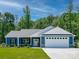 Charming single-story home featuring blue siding, a two-car garage, and a well-maintained front yard at 1994 Hollybrook Ln # 17, Lancaster, SC 29720