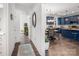 Bright hallway view into kitchen with blue cabinets, white backsplash, and a dining area at 1994 Hollybrook Ln # 17, Lancaster, SC 29720