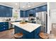 Updated kitchen with blue cabinets, a stainless steel fridge, and a tile backsplash, offering a stylish cooking space at 1994 Hollybrook Ln # 17, Lancaster, SC 29720