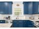 This kitchen has bright blue cabinets and a white tiled backsplash with stainless steel appliances at 1994 Hollybrook Ln # 17, Lancaster, SC 29720