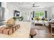 Bright living room with hardwood floors, white sofa, large windows, and modern stainless steel refrigerator at 1994 Hollybrook Ln # 17, Lancaster, SC 29720