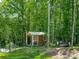 Charming shed nestled in a wooded area with a garden area, a cozy porch, and lounge seating for relaxation at 1994 Hollybrook Ln # 17, Lancaster, SC 29720