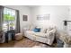 Cozy sitting area with a patterned sofa, throw pillows, natural light, and wood floors at 1994 Hollybrook Ln # 17, Lancaster, SC 29720