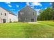 The expansive backyard offers a patio and lush green grass ideal for relaxing or entertaining at 2012 Slippery Rock Ln, Monroe, NC 28112
