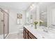 Elegant bathroom featuring a double vanity, tiled shower, and neutral color palette at 2012 Slippery Rock Ln, Monroe, NC 28112