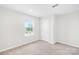 A cozy bedroom with carpet, a window, and a closet at 2012 Slippery Rock Ln, Monroe, NC 28112