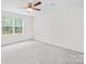 Clean, simple bedroom with carpet, a window, and ceiling fan at 2012 Slippery Rock Ln, Monroe, NC 28112