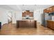 Open kitchen showcasing a central island with granite counters and stainless appliances at 2012 Slippery Rock Ln, Monroe, NC 28112