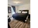 A cozy bedroom features hardwood floors, a dark bed frame, and natural light at 2025 Kisatchie Dr, Hickory Grove, SC 29717