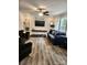 Comfortable living room featuring an accent wall, modern decor, and ample seating at 2025 Kisatchie Dr, Hickory Grove, SC 29717