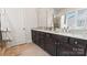 Bathroom featuring a double vanity with granite countertops and dark wood cabinets at 2518 Marshall Pl, Charlotte, NC 28203