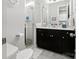 Modern bathroom featuring a glass-enclosed shower, dark cabinets, marble countertops, and a bright, clean design at 2518 Marshall Pl, Charlotte, NC 28203