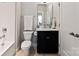 Cozy bathroom with white subway tile, a vanity with a black base, and neutral wall paint at 2518 Marshall Pl, Charlotte, NC 28203