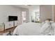 Bright bedroom with an ornate headboard, white bedding, and hardwood floors, providing a serene retreat at 2518 Marshall Pl, Charlotte, NC 28203