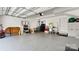 View of the garage with epoxy floor, storage shelves, and utility equipment, offering ample space at 2518 Marshall Pl, Charlotte, NC 28203