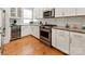 Modern kitchen features white cabinets, stainless appliances, and granite countertops at 2518 Marshall Pl, Charlotte, NC 28203