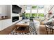 Living room with large windows, a fireplace, and modern comfortable decor at 2518 Marshall Pl, Charlotte, NC 28203
