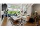 Bright living room with large windows, hardwood floors, and a modern fireplace, creating a welcoming atmosphere at 2518 Marshall Pl, Charlotte, NC 28203