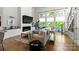 Open-concept living room with fireplace, large windows, modern decor, and hardwood flooring for a cozy aesthetic at 2518 Marshall Pl, Charlotte, NC 28203