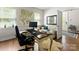 Well-lit home office featuring large windows, a comfortable sofa, and stylish furnishings at 2518 Marshall Pl, Charlotte, NC 28203