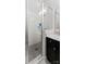Tiled shower with a glass door, featuring a built-in shelf and modern fixtures, offering a sleek design at 2518 Marshall Pl, Charlotte, NC 28203