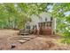 View of the home's backyard, featuring a deck, hot tub, and lush landscaping at 2608 Yarrow Rd, Charlotte, NC 28213