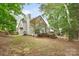 Spacious backyard featuring a large deck, hot tub, and mature trees, perfect for outdoor living at 2608 Yarrow Rd, Charlotte, NC 28213