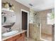 Updated bathroom features a walk-in shower with glass enclosure, granite countertop, and elegant fixtures at 2608 Yarrow Rd, Charlotte, NC 28213