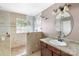Well-lit bathroom with tiled walk-in shower, granite countertop, and modern fixtures at 2608 Yarrow Rd, Charlotte, NC 28213