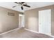 Bedroom with ceiling fan, neutral paint, and access to other rooms in the house at 2608 Yarrow Rd, Charlotte, NC 28213