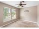 Well-lit bedroom with a ceiling fan, a window, and neutral-toned walls that let in natural light at 2608 Yarrow Rd, Charlotte, NC 28213