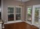 Dining room with wood floors, neutral paint, large windows and a door to the outside patio at 2608 Yarrow Rd, Charlotte, NC 28213