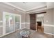 Dining room featuring a sliding barn door, sliding glass door to deck, neutral walls, crown molding, and carpet at 2608 Yarrow Rd, Charlotte, NC 28213
