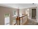 Bright hallway with hardwood railings and large windows allowing for plenty of natural light at 2608 Yarrow Rd, Charlotte, NC 28213