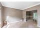 Spacious living room with neutral carpet, trim, and walls, offering a versatile area for relaxing and entertaining guests at 2608 Yarrow Rd, Charlotte, NC 28213
