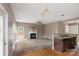 Bright living space featuring a modern fan, fireplace, and view of the kitchen at 2608 Yarrow Rd, Charlotte, NC 28213
