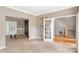 Inviting living room featuring neutral walls, carpet, and hardwood floors, complemented by a rustic sliding barn door at 2608 Yarrow Rd, Charlotte, NC 28213