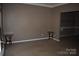 Carpeted living room with two end tables, a neutral color palette, and an open doorway at 2608 Yarrow Rd, Charlotte, NC 28213