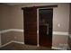 A living room entrance with a wood sliding door provides a stylish transition to other areas at 2608 Yarrow Rd, Charlotte, NC 28213