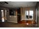 Open concept floor plan connects the kitchen and dining room with plenty of natural light and hardwood flooring at 2608 Yarrow Rd, Charlotte, NC 28213