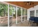Looking out from the screened porch, the wooden back deck with hot tub is visible at 2608 Yarrow Rd, Charlotte, NC 28213