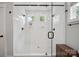 Modern bathroom featuring a glass-enclosed shower with dual shower heads, tiled walls and black hardware at 2637 Springway Dr, Charlotte, NC 28205