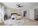 Bedroom with closet and ensuite bathroom, featuring a decorative rug, large windows and ceiling fan at 2637 Springway Dr, Charlotte, NC 28205