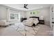 Luxurious bedroom with a large bed, decorative rug, ceiling fan, and ample natural light from large windows at 2637 Springway Dr, Charlotte, NC 28205