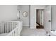Cozy Bedroom with a crib and transition to living area with hardwood floors at 2637 Springway Dr, Charlotte, NC 28205