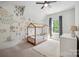 Charming bedroom with a wooden bed frame, ceiling fan and a window allowing natural light to flow in at 2637 Springway Dr, Charlotte, NC 28205