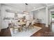 An open dining area featuring modern furnishings and an open transition to the kitchen at 2637 Springway Dr, Charlotte, NC 28205