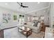 Open-concept living room with hardwood floors, a comfortable sectional, and plenty of natural light at 2637 Springway Dr, Charlotte, NC 28205