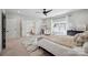 Sun-filled main bedroom with ensuite bathroom and closet, featuring a decorative rug and a ceiling fan at 2637 Springway Dr, Charlotte, NC 28205
