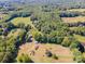 Extensive aerial view revealing the property's several structures and lush treed surroundings at 290 Glenmere Ln, Mooresville, NC 28115